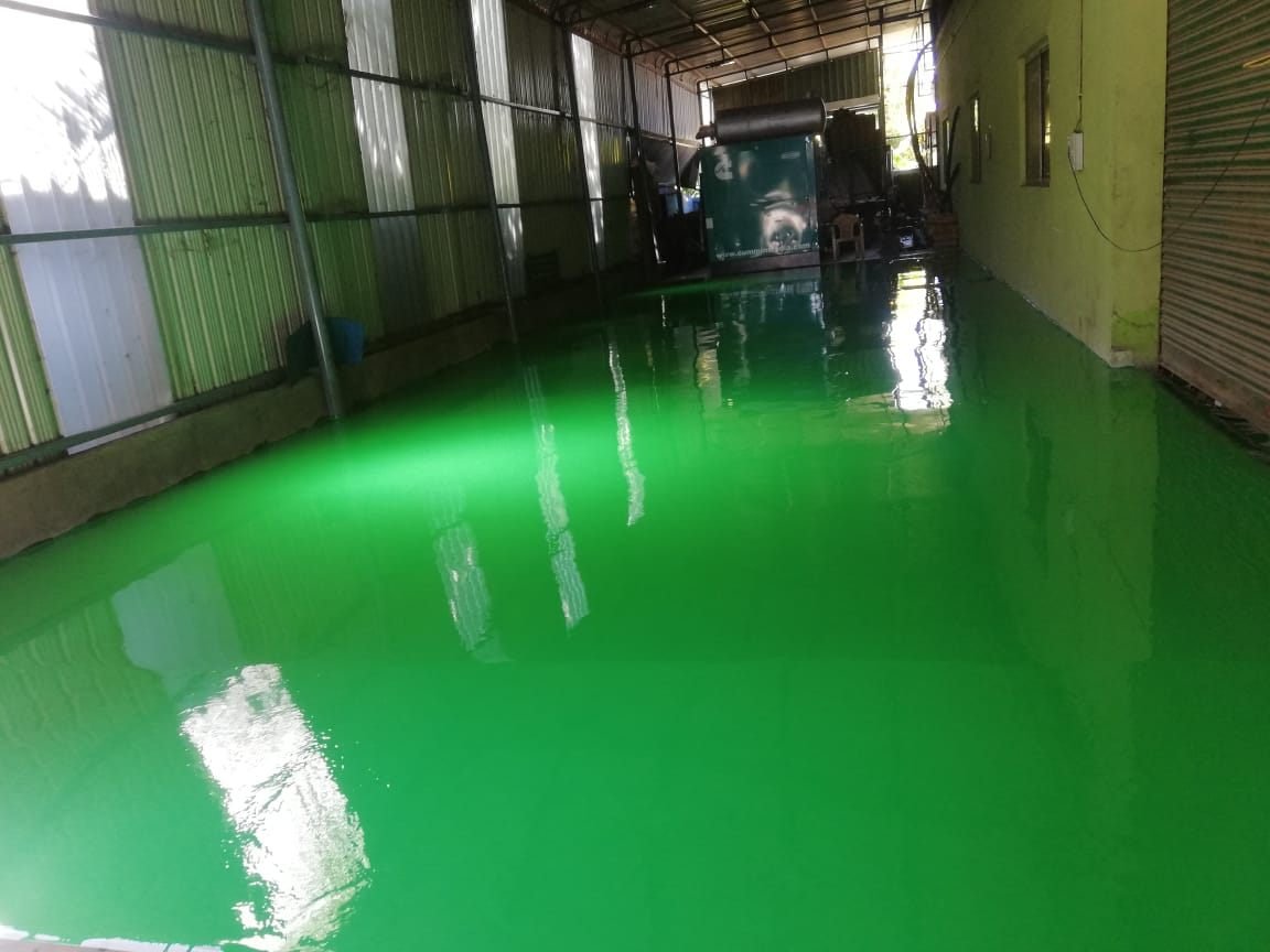 Solid green epoxy floor in a warehouse